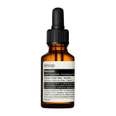 Aesop Resolute facial concentrate in an amber glass dropper bottle with a black cap and white label, shown on a plain white background.