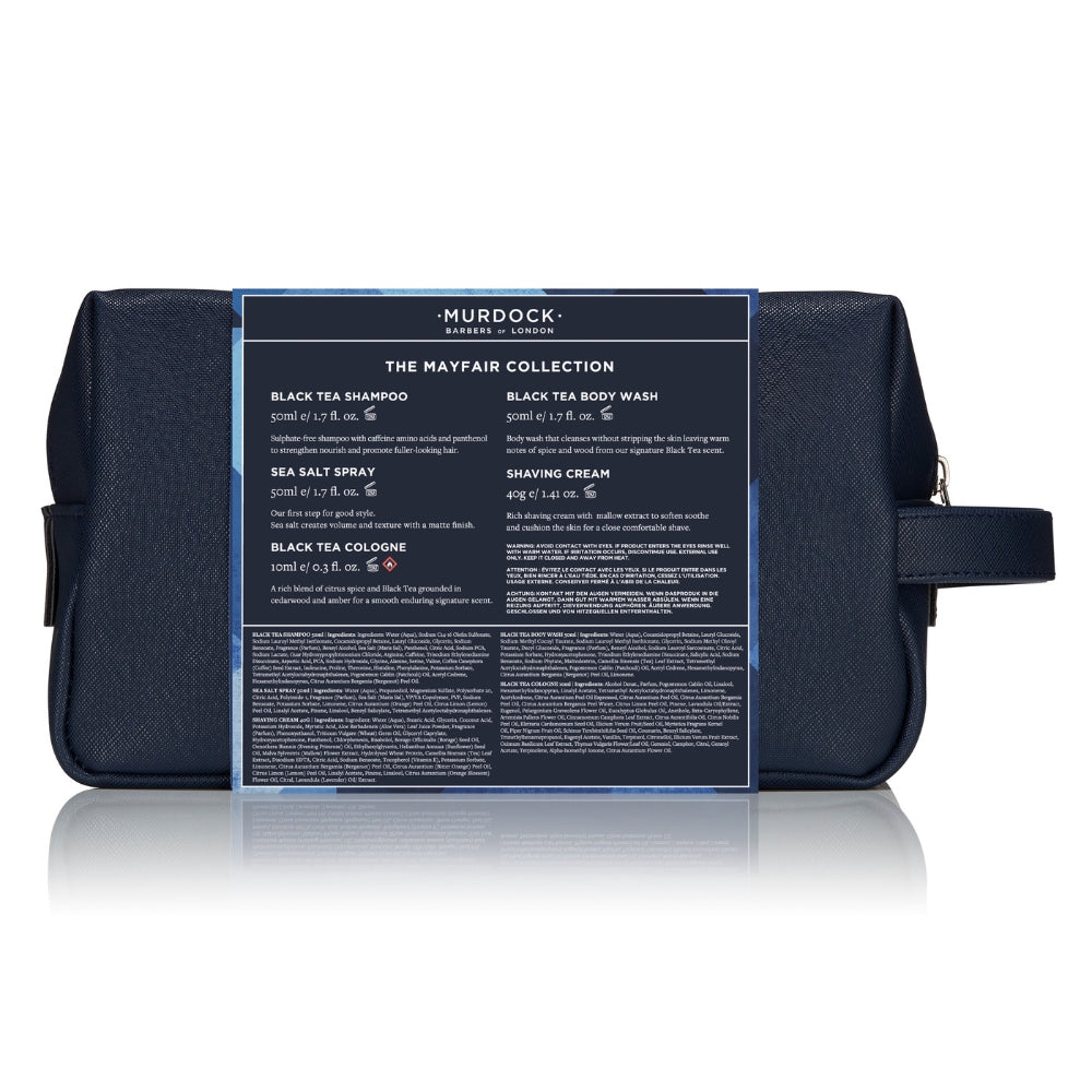 A dark navy blue Murdock London travel toiletry bag with a clear front label displaying product details from 'The Mayfair Collection'.