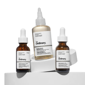 Three 'The Ordinary' skincare bottles on a white background